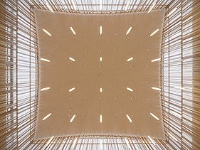 Photo of a wooden ceiling with many structures and strokes can be seen.