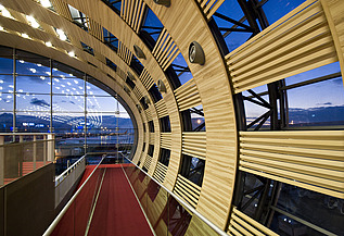 Photo of the Charles de Gaulle Paris airport terminal from the inside. Curved wooden construction.