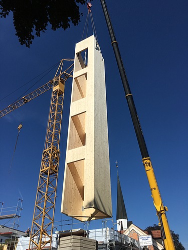 Photo of a wooden elevator shaft during crane assembly.