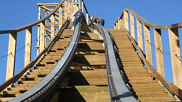 Photo of a roller coaster with wooden rails.