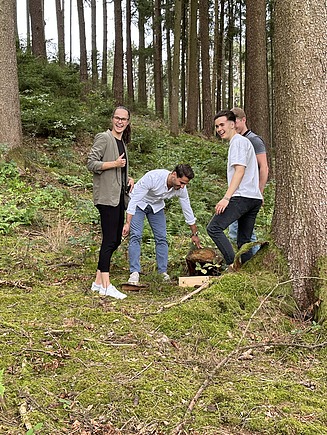 Photo of four people in the forest.