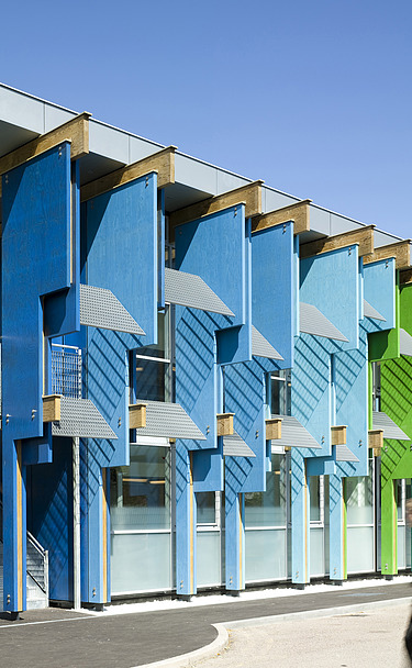 Community School, Longford Photo of a school building with colorful façade elements made of laminated veneer lumber.