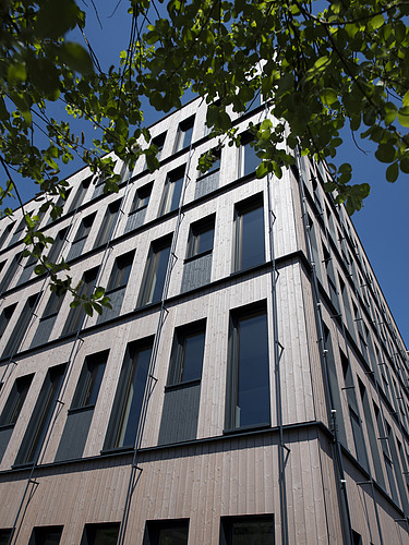 Photo of a multi-storey timber building. Location ZÜBLIN Timber.