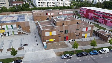 Aerial view of a wooden school building.
