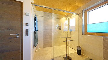 Photo of a house made of LENO cross laminated timber. Bathroom with many wooden surfaces.