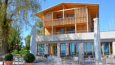 Photo of the yacht club clubhouse in Prien am Chiemsee. You can see a modern wooden building.
