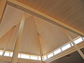 Photo of Burgweinting church from the inside. You can see the wooden roof construction.