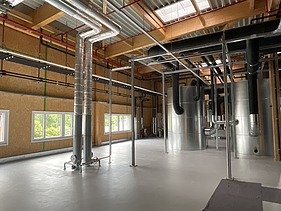 Photos of a storage room with timber frame walls.