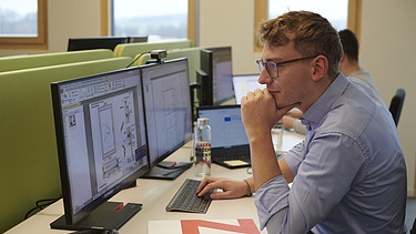 Photo of Michael at work in the office. 