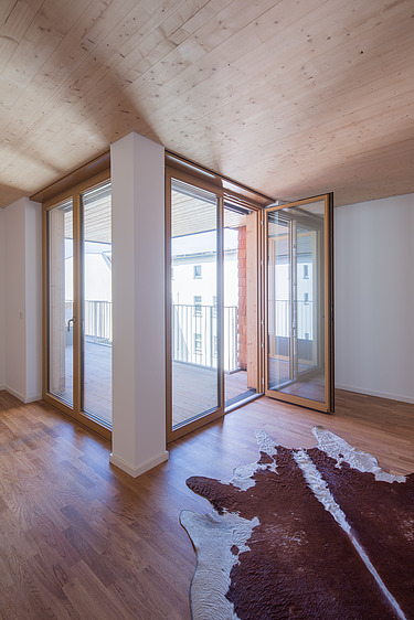 Foto eines hellen Innenraumes mit Holzdecke.