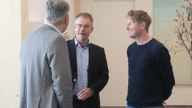 News ZÜBLIN Timber Photo of three men talking.