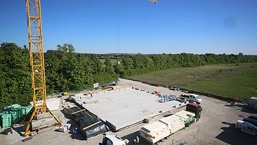 Construction site photo. Truck brings the first cross-laminated timber elements.