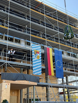 A ceremonial topping-out speech by Sven Harsch, site manager for timber construction. 