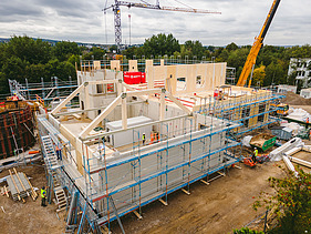 Foto der Montage der Universität Witten-Herdecke. Man sieht LENO-Brettsperrholzelemente die gerade montiert werden.