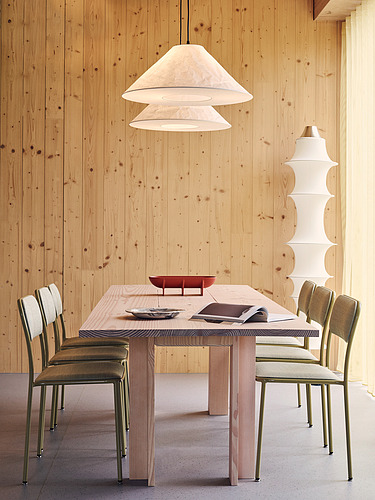 Photo of an interior of the Black and White office in London. You can see wooden surfaces and a table with chairs.