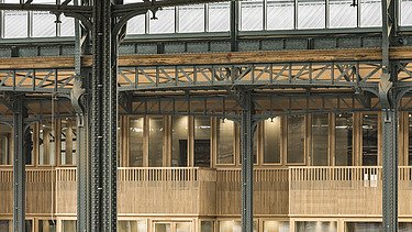 Photo inside the hall of Gare Maritime Brussels. View of a balcony parapet.
