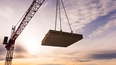 Photo of the Collegium Academicum in Heidelberg during assembly. You can see a LENO wooden element hovering on the crane.