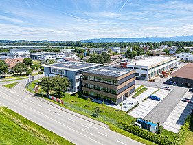 Aerial view of the new timber building with timber and glass façade and flat roof from ZÜBLIN's Lake Constance division.