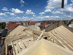Photo of a wooden extension. You can see a wooden roof truss.