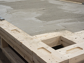 Photo of a horizontal rib element with a layer of concrete in the ZÜBLIN Timber production hall.