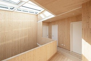 Photo of a wooden house. Detailed picture of the 1st floor hallway. Many LENO wooden walls can be seen.