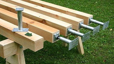 Photo of the legs of the stanchions mounted on squared timber and resting on trestles.