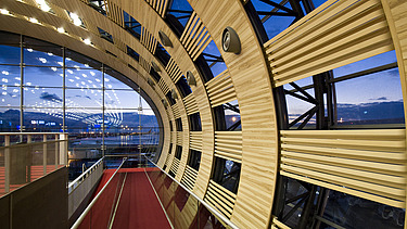 Photo of the Charles de Gaulle Paris airport terminal from the inside. Curved wooden construction.