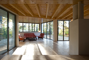 Foto eines modernen Holzhaus. LENO-BSP. Möblierter Wohnbereich innen.