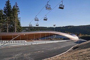 Photo of a toboggan run. You can also see a chairlift in the picture.