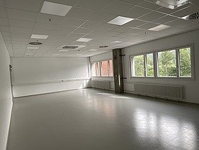 Photo of a large, bright room that is empty.