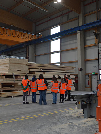 Photo of young girls receiving a factory tour at ZÜBLIN Timber.