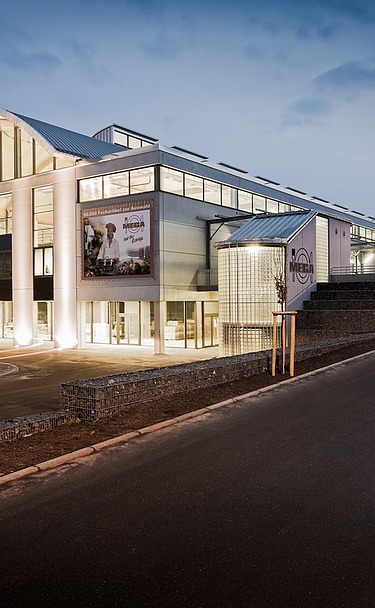 Foto des MEGA-Markts in Stockach. Nachtaufnahme des beleuchteten Gebäudes.