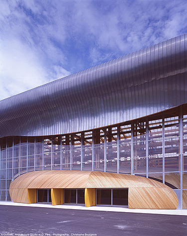 Photo of the Mirecourt school in France. You can see a section of the wooden building.