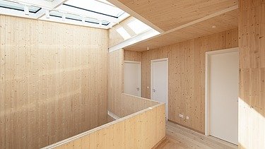Photo of a wooden house. Detailed picture of the 1st floor hallway. Many LENO wooden walls can be seen.