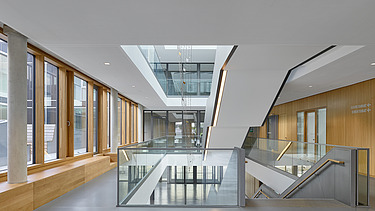 Interior photo of the Munich North Grammar School. You can see a corridor area and the timber mullion and transom façade.