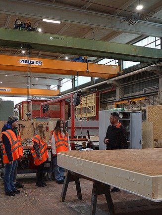 Photo of young girls receiving a factory tour at ZÜBLIN Timber.