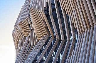 Photo of a detailed section of a wooden façade with individual wooden slats.