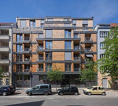 Photo of a multi-storey residential complex made of wood.