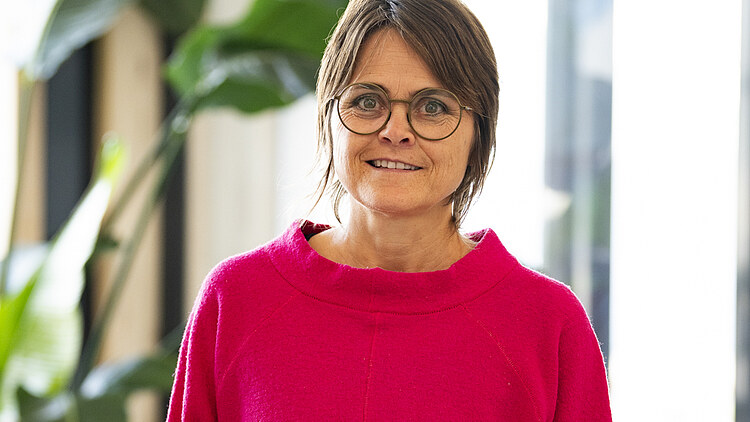 Andrea in an office background.