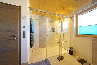 Photo of a house made of LENO cross laminated timber. Bathroom with many wooden surfaces.