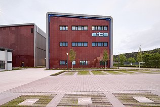 Photo of a wooden building with a red façade.