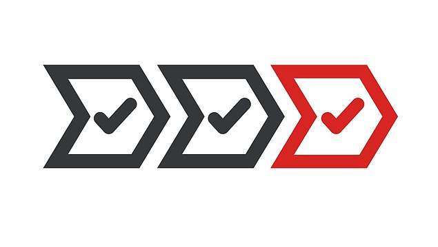 Photo of an arrow symbol with hook. Colors black and red.