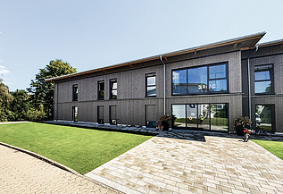 Foto des Eltern-Kind-Hauses in Gailingen. Man sieht ein Gebäude mit Holzfassade.