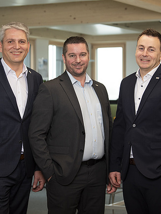 Photo of three men.