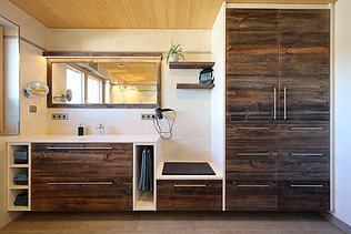 Photo of a house made of LENO cross laminated timber. Bathroom with many wooden surfaces.
