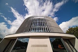 Photo of the Globe Theater in Coburg. You can see the entrance area of the round wooden building.
