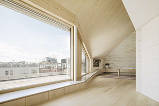 Photo of a modern interior with a large glass front and visible LENO cross-laminated timber elements.