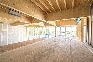 Foto eines Innenraumes mit Holzrahmenbau-Deckenelementen. JOWAT Haus der Technik.