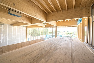 Photo of an interior with timber frame ceiling elements. JOWAT House of Technology.