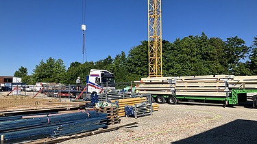 Baustellenbild. LKW bringt die ersten Brettsperrholzelemente.